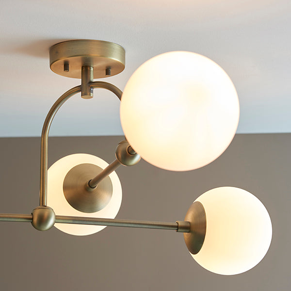 Matt antique brass semi-flush with opal glass