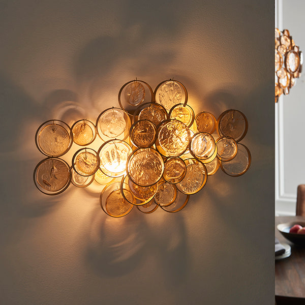 Antique gold wall light with clear and amber glass details