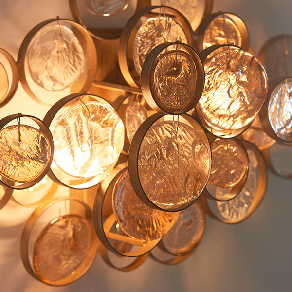 Antique gold wall light with clear and amber glass details