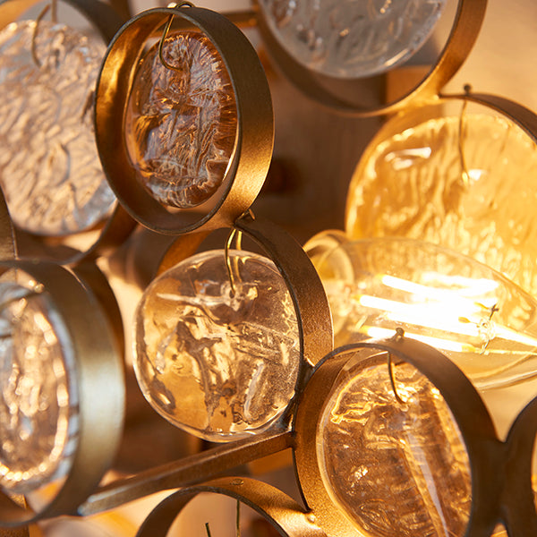 Antique gold wall light with clear and amber glass details