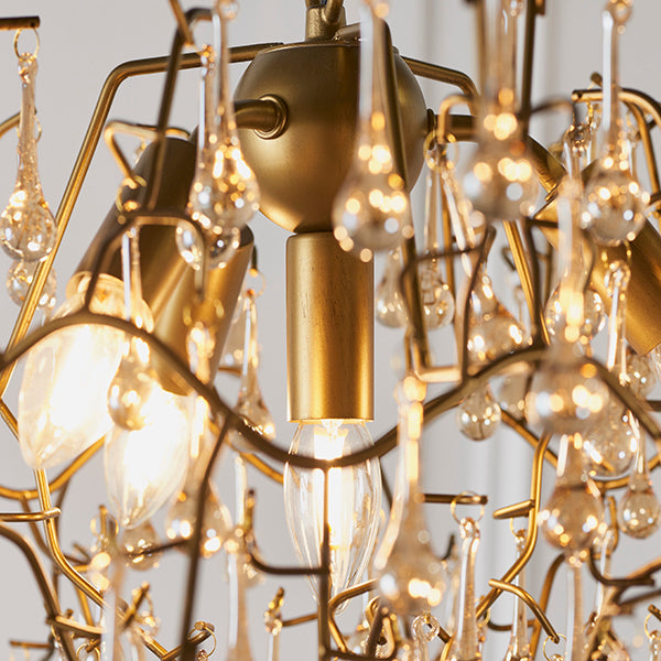 Aged gold branch chandelier with glass droplets